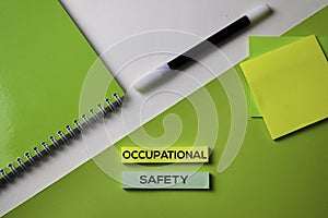 Occupational Safety text on top view office desk table of Business workplace and business objects