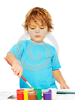 Occupied little boy painting photo