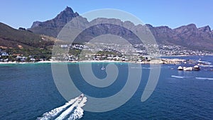 Ocean, adventure and speed boat with mountain, island vacation and blue sky on horizon. Summer sailing, sea transport