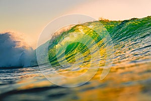 Ocean barrel wave at sunset. Perfect wave for surfing in Hawaii