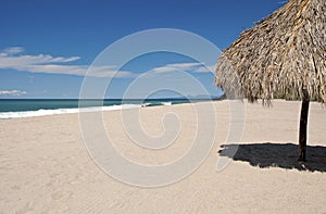 Ocean, beach, sand and palapa photo