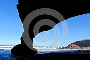 Ocean beach stone arch silhouette photo