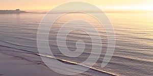 Ocean at Blacks Beach with sunset in the horizon