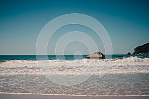 Ocean and a blue sky with some clounds as background