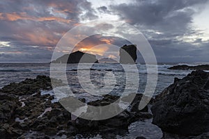 The ocean is calm and the sky is cloudy