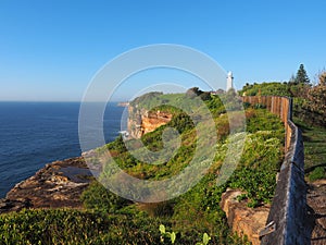 Ocean Cliffs With a White Lighthouse