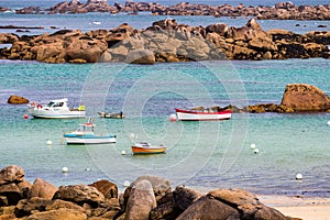 Ocean coast in Meneham village with granite rocks and boats, Kerlouan, Finistere, Brittany (Bretagne), France