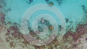Ocean, coral reef and woman snorkeling from drone with water, freedom and tropical island holiday. Diving, adventure and