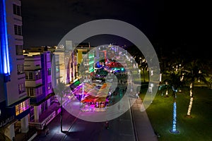 Ocean Drive Miami Beach night neon lights and tourists walking photo