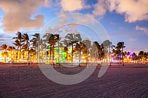 Ocean Drive Miami Beach at sunset. City skyline with palm trees at dusk. Art deco on the South beach
