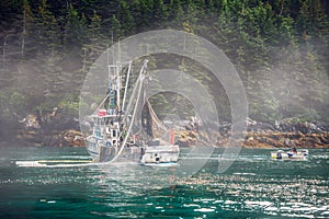 Ocean fishing boat set up the net for salmon in Alaska bay.
