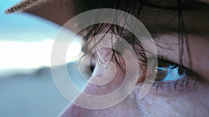 Ocean Gaze: Close-Up of Woman's Eyes Taking in the Beauty of the Sunset on the Sea