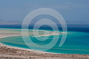 ocean landscape. blue ocean, sand beach with lagoon and watersport (kitesurfing and windsurfing)