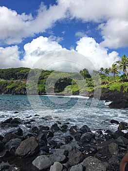 Black sand beach Ocean scene in maui hawaii