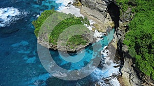 Ocean landscape with scenic rocks and ocean with waves in Indonesia. Aerial view