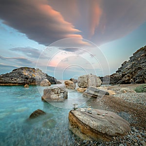 Ocean Landsckape. Sunset. Sea. Evening time on the sea shore. Big rocks and colorful dramatic clouds. Beautiful landscape