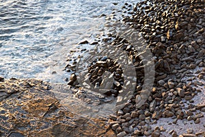 Ocean lapping on pebbles and rocks photo