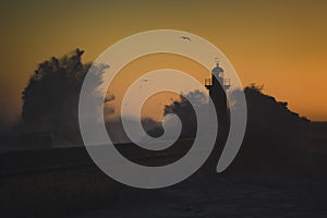 An ocean lighthouse in the middle of a storm.