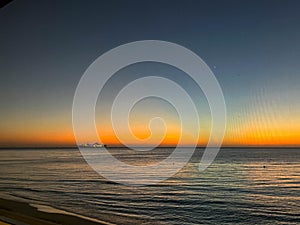 The ocean off of 7 mile beach in Cayman Islands on a beautiful sunset sky evening