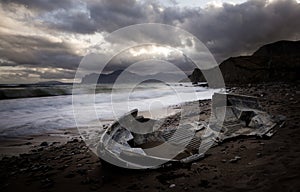 Ocean, old broken boat on shore