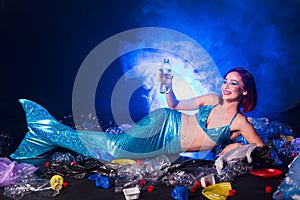 Ocean plastic pollution concept. Mermaid lives to polluted habitat.
