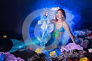 Ocean plastic pollution concept. Mermaid lives to polluted habitat.