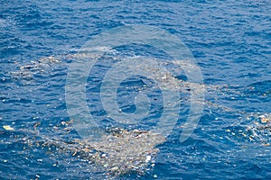 Ocean Pollution with Plastic Debris Floating on Water Surface