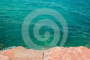 Ocean rocky coast line local scenic landscape photography from above, stone and blue water natural background pattern with empty