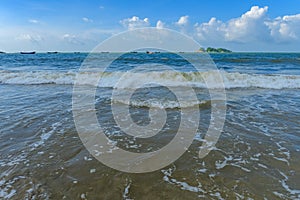 An ocean with sailboats and soft waves in a sunny day horizontal composition