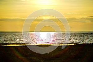 Ocean, sea sunset on the background of the sun going beyond the horizon.  beach and wonderful