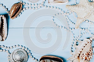 Ocean shells, starfish and pearls on a blue background c