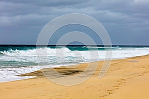 Ocean shore with sandy beach and waves