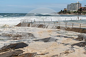 Ocean storm aftermath: A mass of thick foam covered the rocks near rock pool following extreme storm weather at Cronulla, NSW,