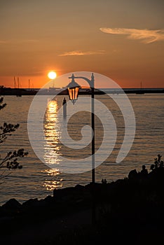 Ocean sunset with a lantern in foregorund