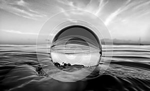 Ocean Surface Ripples and Clouds in Sky Captured in Glass Ball