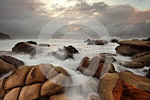 Ocean surges over weathered rocks