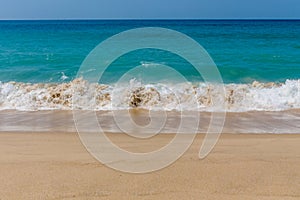 Ocean tide waves on paradise sandy beach
