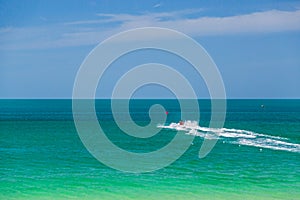 The ocean is turquoise and the boat is far away. Thailand. Samui. Gulf of Thailand. Lamai Beach