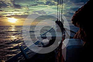 The ocean view from the bow of a sailing ship on the beautiful sunsets