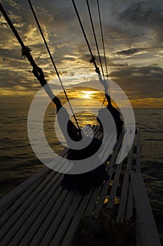 The ocean view from the bow of a sailing ship on the beautiful sunsets