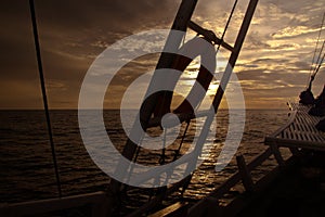 The ocean view from the bow of a sailing ship on the sunsets