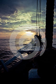 The ocean view from the bow of a sailing ship on the beautiful sunsets