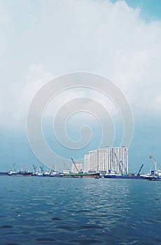 ocean view of buildings and ships, jakarta muara baru