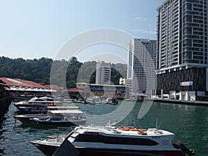 Beautiful sunny day and the ocean view city centre in Jesselton Point Jetty, Kota Kinabalu. Sabah, Malaysia. Borneo.