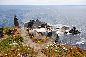 Ocean view from the cliff, natural pool in the volcanic rocks below, Cinco Ribeiras, Terceira, Azores, Portugal photo
