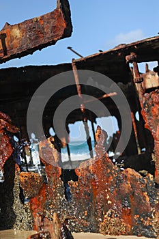 ocean view through a hole in sunken ship stranded on the sand of Australia photo