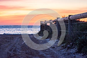 Ocean view of a pathway with a wooden fence