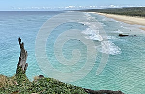 Ocean views and a surf beach taken from a rocky headland on a tropical island paradise off Queensland, Australia