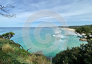 Ocean views and a surf beach taken from a rocky headland on a tropical island paradise off Queensland, Australia