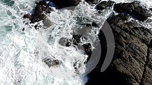 Ocean Water Swirls Amongs Rocks As Seen From Above